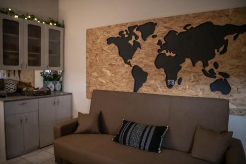 a living room with a couch and a map on the wall at Taygetos Escape Sparta in Perivólia