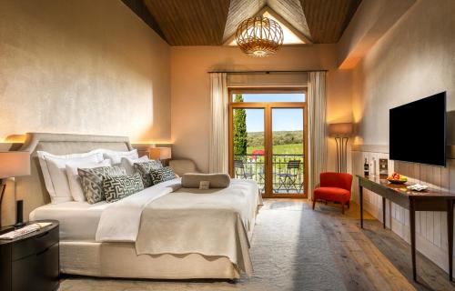 a bedroom with a large bed and a television at Hotel Caeli in Eceabat