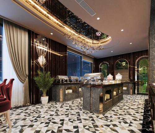 a hotel lobby with a bar and a chandelier at L'Heritage Premium Hanoi Central in Hanoi