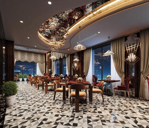 a restaurant with tables and chairs and a chandelier at L'Heritage Premium Hanoi Central in Hanoi