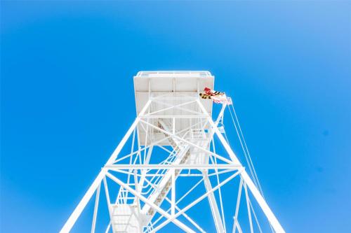 a white tower with a blue sky in the background at Hyatt Place Ocean City Oceanfront in Ocean City
