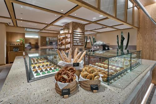 a bakery with various pastries on display in a store at Hotel Indonesia Kempinski Jakarta in Jakarta