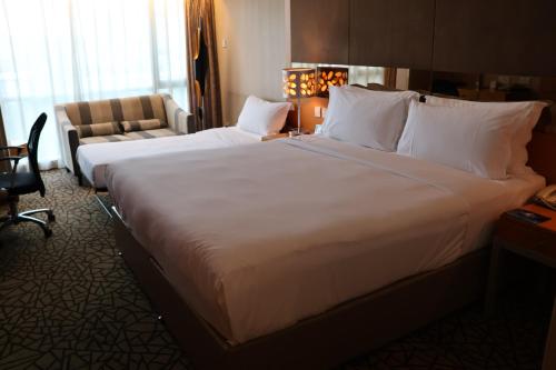 a large white bed in a hotel room at Park Plaza Beijing Science Park in Beijing