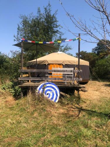 a yurt in a field with a tent at Yourte Les Hulottes en Comminges in Juzet-dʼIzaut