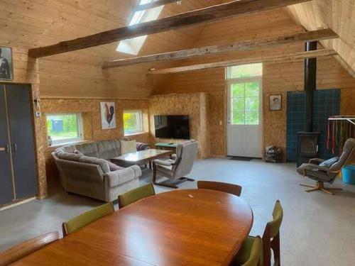 a large living room with a table and chairs at Holiday On Magical Nature Plot For Families in Hadsund