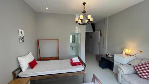 a small room with a bed and a couch at Rocky Cafe & Mini Apartment in Siem Reap