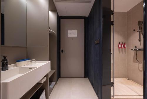 a bathroom with a sink and a toilet and a shower at Atour Light Hotel Beijing Wukesong 301 PLA Hospital in Beijing