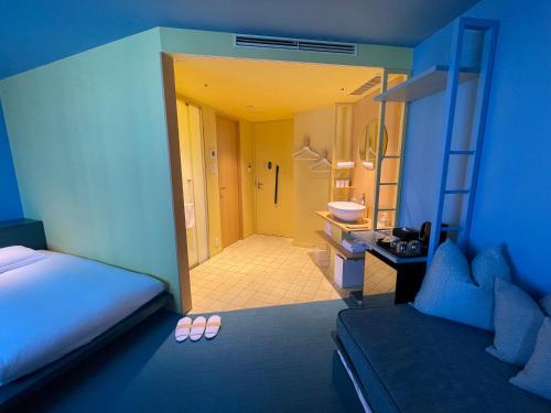 a room with a bedroom with a bed and a bathroom at toggle hotel suidobashi TOKYO in Tokyo