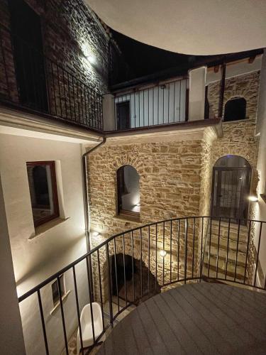 a spiral staircase in a building with a brick wall at Palazzetto Longobardi in Ogliastro Cilento