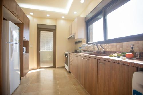 a kitchen with a sink and a window at Akl - Chic Apartments & Balconies in Batroun in Batroûn