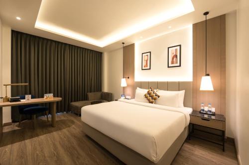 a hotel room with a bed and a desk at Best Western Plus Phagwara in Phagwāra