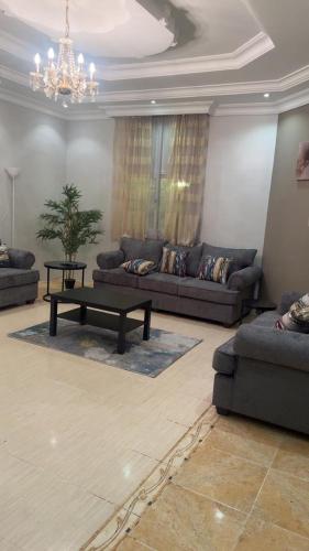 a living room with couches and a coffee table at شقة حي الموظفين ابها in Abha