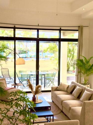 a living room with a couch and a table at Villa Dauphin in Grand Baie