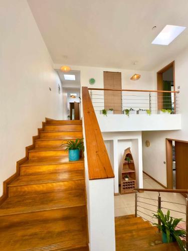 a staircase in a house with wood flooring and a fireplace at Villa Dauphin in Grand Baie