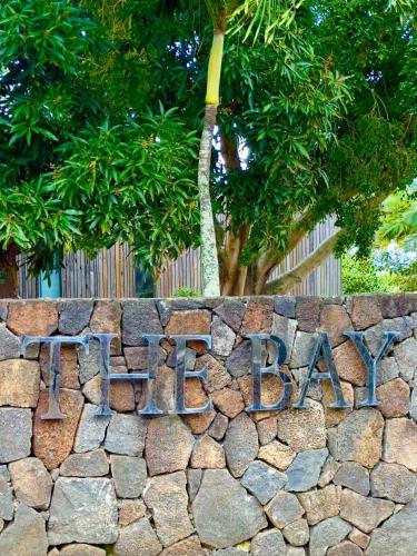 a stone wall with a sign on it at Villa Dauphin in Grand Baie