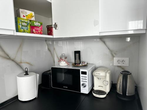 a kitchen counter with a microwave and a toaster at Great View & Parking - Harmony Premium Residence in Timişoara