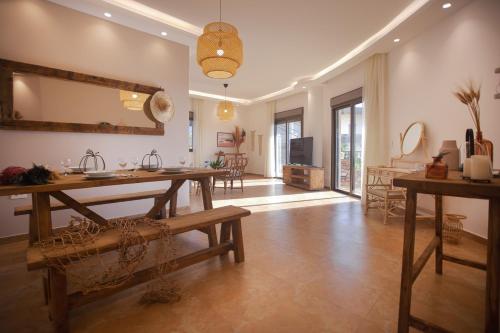 a living room with a table and a mirror at Akl - Chic Apartments & Balconies in Batroun in Batroûn