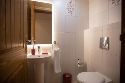a bathroom with a sink and a toilet at Akl - Chic Apartments & Balconies in Batroun in Batroûn