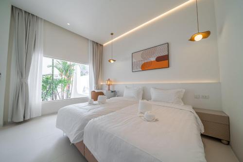 Postel nebo postele na pokoji v ubytování Pattaya Interstellar Village Resort House