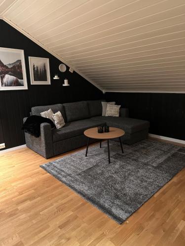 a living room with a couch and a table at Private cozy apartment in Kaldfjord in Tromsø