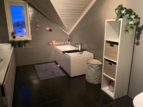 a bathroom with a sink and a toilet and a sink at Private cozy apartment in Kaldfjord in Tromsø