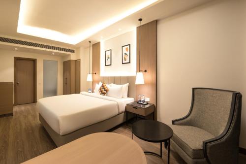 a hotel room with a bed and a chair at Best Western Plus Phagwara in Phagwāra