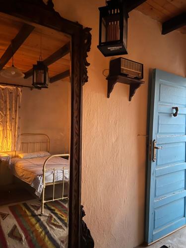 a mirror in the corner of a room with a bed at Eeri Siwa Oasis in siwa oasis