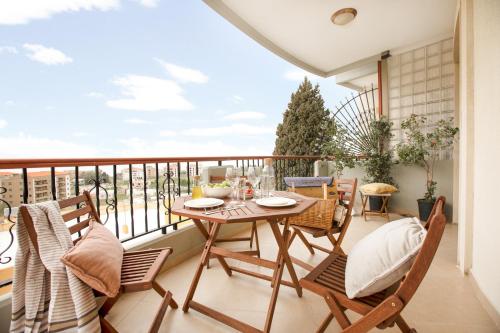 a patio with a table and chairs on a balcony at Akl - Chic Apartments & Balconies in Batroun in Batroûn