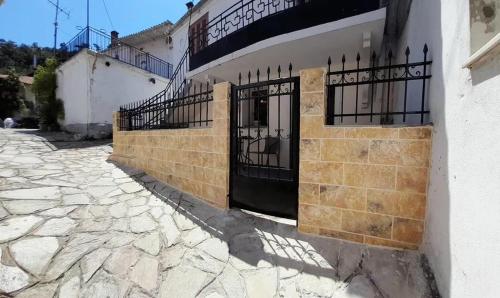 a building with two gates on the side of it at Kunada home in Potamia