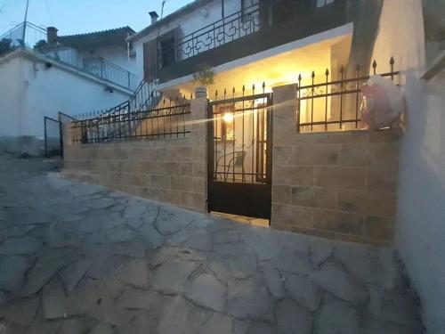 a house with a gate and a stone walkway at Kunada home in Potamia