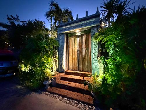a small house with a wooden door and some plants at Arawan Pool Villa Hua Hin in Hua Hin
