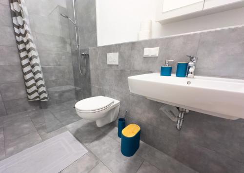 a bathroom with a white sink and a toilet at Moderne Wohnung im Zentrum der Altstadt - Altbau Flair, WLAN in Ingolstadt