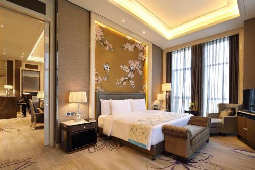 Ένα ή περισσότερα κρεβάτια σε δωμάτιο στο Wanda Realm Guangyuan