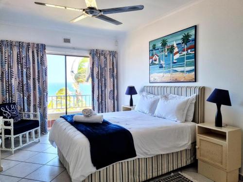 a bedroom with a bed with a view of the ocean at Shaka's Rock Sea Vista - 17 Siesta in Ballito