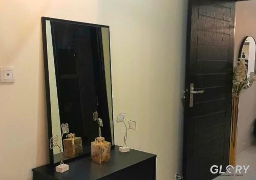 a bathroom with a black mirror and a black door at 1-BHK Designer Black at Zameen Opal in Lahore