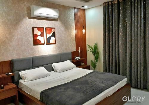 a bedroom with a large bed in a room at 1-BHK Designer Black at Zameen Opal in Lahore