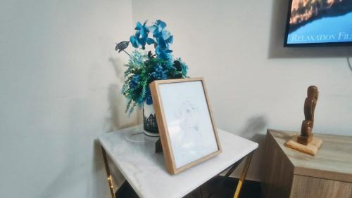 a table with a picture and a vase with a plant at Luxury Villa in Ras al Khaimah