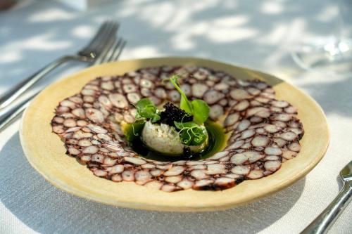 a plate of food with beans on a table at Hotel Caeli in Eceabat