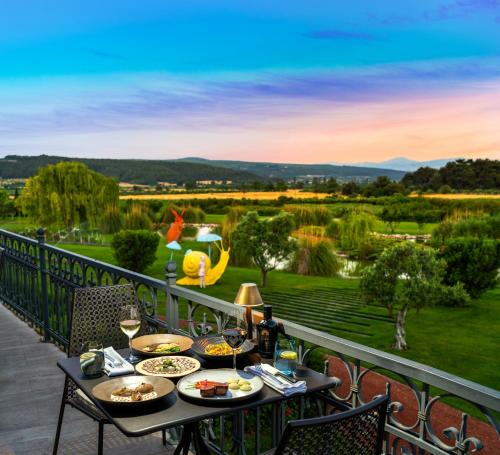 a table with food on a balcony with a view at Hotel Caeli in Eceabat