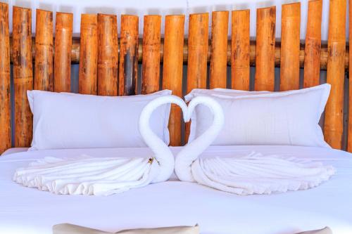 a bed with two swans made out of pillows at Samburu Elephant Lodge in Isiolo