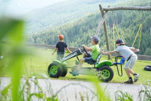 a group of people riding on a four wheeler at Hüttendorf Schlögelberger in Sankt Margarethen im Lungau