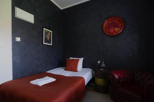 a hotel room with two beds and a chair at Hotelli Verstas in Nakkila