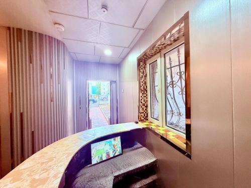 a room with a bed with a mirror on the wall at City Hostel & Tours in Ulaanbaatar
