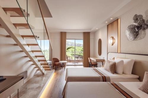 a hotel room with a bed and a staircase at Akka Antedon Hotel - Premium Ultra All Inclusive in Beldibi