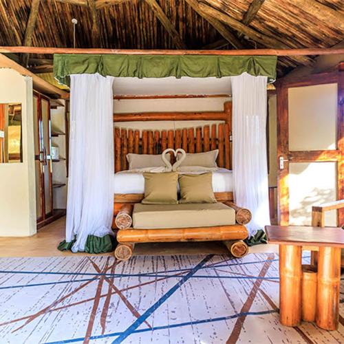 a bed with a canopy in a room at Samburu Elephant Lodge in Isiolo