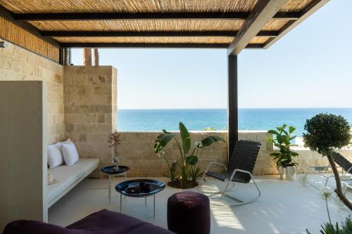 a living room with a view of the ocean at My Cave Blue Iconic Designer Villa by etouri in Rethymno