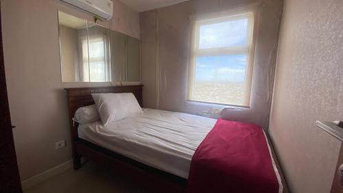PampangにあるApart VidaView Unit AT 31A By Millproの窓のある小さな部屋にある小さなベッド