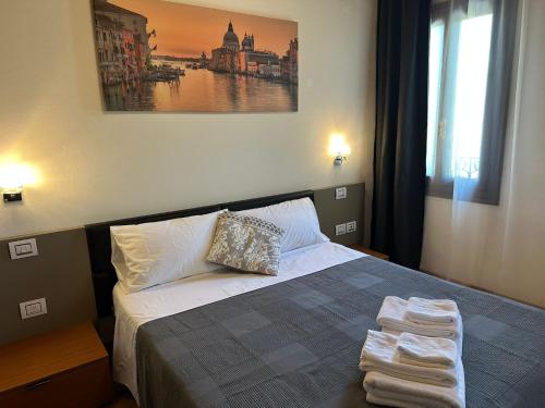 a bedroom with a bed with towels on it at Osteria Locanda Veneta in Mirano