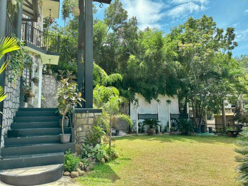 a house with a staircase in a yard at Winterfell Bandarawela in Bandarawela