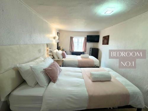 a hotel room with two beds and a couch at Anchor's Drop in Blue Anchor